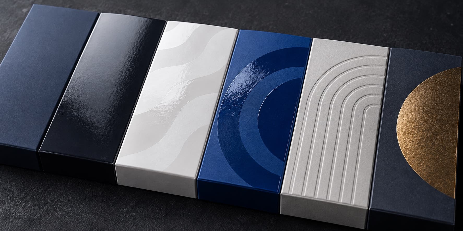 Illustrative packaging finish samples showing different sheen, embossing and foil effects